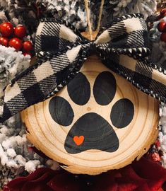 a dog paw ornament hanging on a christmas tree