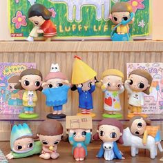 many small figurines are on display in front of a sign that says happy life