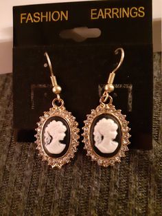 Pair of Round Cameo Earrings in black and white. Good day, my lady! These beautiful cameo earrings feature a young lady in cameo. Perfect for birthday, holidays, cosplay or an accent piece for your daily wear. Can be used for Steampunk, Victorian, Edwardian, Cosplay and Halloween costumes. Take them home and enjoy! Pirate Bar, Victoria Era, Season Outfits, Steampunk Victorian, Cameo Earrings, Accent Pieces, Good Day, Jewelry Earrings Dangle, Daily Wear