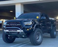 a black toyota truck parked in a parking lot