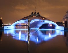 a boat is lit up with blue lights on it's hulls in the water