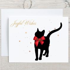 a card with a black cat wearing a red bow