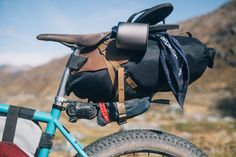 the back pack is attached to the handlebars of a bike in the mountains