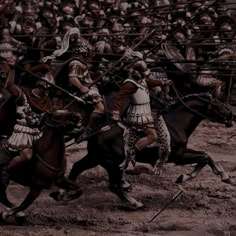 a group of men riding on the backs of horses next to each other in front of a crowd