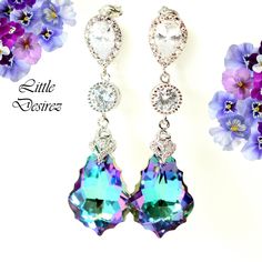 "These gorgeous and timeless Swarovski Vitrail Light Earrings have a Victorian touch of elegance and romance. The baroque pendants have classic scroll-shaped silhouettes and are precision beveled/faceted to enhance the color and characteristic of the crystal, making each piece a glistening treasure! Perfect for brides, bridesmaids and special occasions! Earrings made with: - 22mm GENUINE Swarovski Vitrail Light Baroque crystals. The crystals emit so much shine and sparkle as it changes colors at Elegant Iridescent Pierced Earrings, Purple Pierced Earrings For Wedding, Elegant Iridescent Jewelry For Pierced Ears, Iridescent Wedding Jewelry With Matching Earrings, Elegant Iridescent Crystal Earrings Gift, Iridescent Jewelry With Matching Earrings For Wedding, Elegant Lavender Nickel-free Earrings, Elegant Nickel-free Lavender Earrings, Elegant Purple Dangle Clip-on Earrings