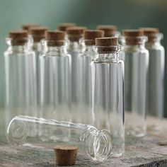 several empty glass bottles with corks on a table