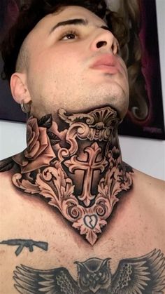 a man with tattoos on his neck has an owl and cross tattoo on it's chest