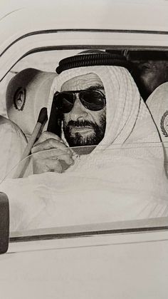 an old photo of a man and woman in a car