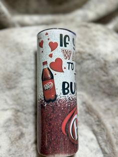 a can of budweiser is sitting on a bed with hearts and the words love to budweiser printed on it