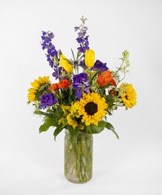 a vase filled with lots of colorful flowers