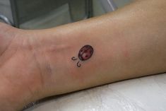 a ladybug tattoo on the left ankle