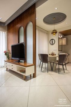 a living room filled with furniture and a flat screen tv on top of a wooden stand