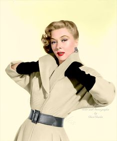 a woman in a beige coat and black gloves