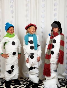 three people dressed up in snowmen costumes