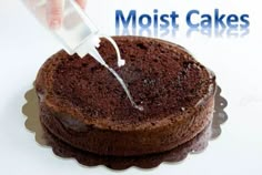 a person is spreading icing on a chocolate cake with the words moist cakes above it