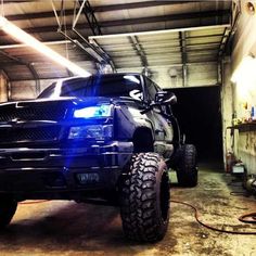 a large truck parked in a garage next to a fire hydrant