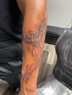 a man with a bird tattoo on his arm