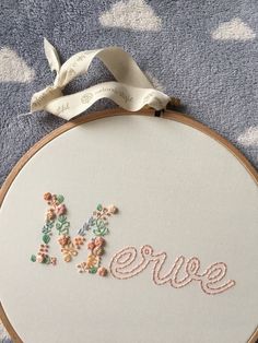 a close up of a embroidery on a piece of cloth with the word errie written in it