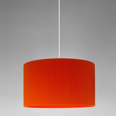 an orange lamp shade hanging from a ceiling