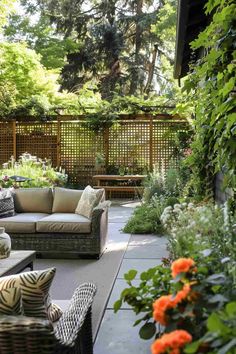 an outdoor living area with couches, tables and plants