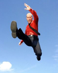 a man flying through the air while riding on top of a pair of black shoes