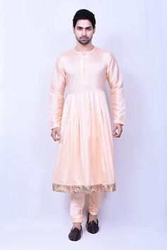 Peach longline sherwani with floral and geometric pattern multi colored embroidery. Comes with peach anarkali kurta and churidar.
Components: 3
Pattern: Embroidered
Type Of Work: Floral, Geometric
Neckline: Sherwani: Mandarin, Anarkali: Notched
Sleeve Type: Full
Fabric: Banglori Silk
Color: Peach
Other Details: 
Embellished sherwani buttons
Side pocketed pant
Note: Neckpiece worn by the model is not for sale
Occasion: Groom,Wedding - Aza Fashions Peach Kurta With Zari Work And Long Sleeves, Peach Kurta With Zari Work, Designer Naqshi Kurta For Navratri, Navratri Anarkali Sherwani With Chikankari Embroidery, Long Sleeve Peach Kurta With Zari Work, Peach Long Sleeve Kurta With Zari Work, Festive Anarkali Sherwani With Straight Kurta, Anarkali Style Sherwani With Straight Kurta For Navratri, Festive Anarkali Kurta With Naqshi