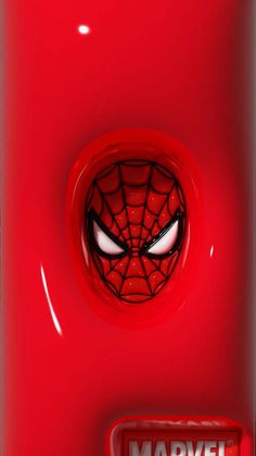 a close up of a red refrigerator with a spiderman face on it's door