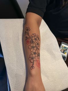 a person with a flower tattoo on their arm