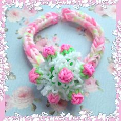 a close up of a ring made out of plastic beads and flowers on a blue background