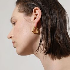 A confident style never goes unnoticed–allow your personality to shine through with these folded triangle hoop earrings, an ode to those who love retro-geometric shapes and artistic creativity. A subversive-basic design blended with wearability gives these hoops endless possibilities.

Size: 24x24mm
Material: 18k Gold Plated On Brass Modern Triangle Gold Hoop Earrings, Trendy Gold Triangle Earrings, Everyday Gold Triangle Earrings, Geometric Gold Hoop Earrings For Everyday, Minimalist Triangle Earrings For Everyday, Gold Geometric Hoop Earrings For Everyday, Minimalist Triangle Hoop Earrings As Gift, Everyday Geometric Gold Hoop Earrings, Modern Geometric Gold Hoop Earrings