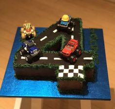 a birthday cake with cars on the road