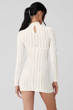 This semi-sheer, pointelle dress is prime for the holiday party circuit. It fits close to the body with a mock neck, long sleeves, and an upper-thigh-length hem. Don’t miss the cute keyhole cutout in back. Style it with a tonal bra and underwear underneath, then add boots and a sherpa jacket to complete the look. White High Neck Mini Dress For Party, White Sheer Long Sleeve Mini Dress, White Mini Dress With Sheer Sleeves For Night Out, White High Neck Mini Dress For Night Out, White Stretch Dress With Sheer Sleeves, White Mini Dress With Sheer Sleeves For Brunch, White Mini Dress With Sheer Sleeves For Date Night, White High Neck Mini Dress For Date Night, White High Neck Mini Dress For Spring