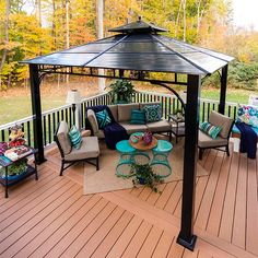 a gazebo on a deck with chairs and tables