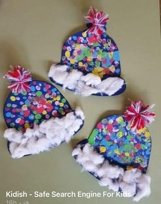 three children's hats made out of felt and cotton balls are on the table