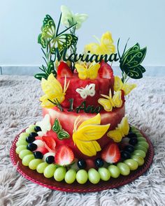 a watermelon cake decorated with butterflies and flowers