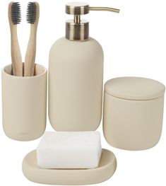 bathroom accessories including soap dispenser, toothbrush holder and toiletries on white background