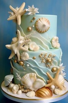 a blue cake with sea shells and starfish on it