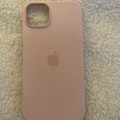 an iphone case sitting on top of a white carpet next to a cell phone charger