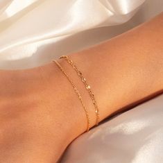 "Elevate your wrist game with our Gold Dainty Double Layered Bracelets. These stylish bracelets feature a delicate double-layered design, plated in elegant gold. Personalize them with an initial heart charm, adding a touch of uniqueness and sentimentality.  #YOU MAY LIKE THIS Personalized Mother of Pearl Bracelet https://www.etsy.com/listing/1487860290/personalized-mother-of-pearl-bracelet Gold cotton rope bracelet https://www.etsy.com/listing/1504342961/gold-cotton-rope-bracelet-personalized # Gold Layered Bracelets, Gold Bracelet Simple, Gold Bracelets Stacked, Pearl Bracelet Gold, Dainty Gold Bracelet, Wrist Game, Gold Bracelet For Women, Stylish Bracelet, Gold Armband