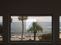 two windows with cars parked in front of the ocean and palm trees on the beach