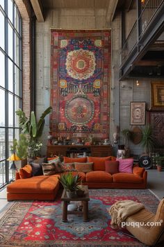 a living room filled with lots of furniture next to a large tapestry on the wall