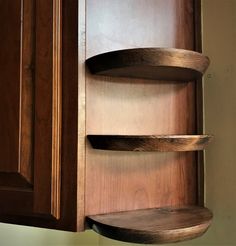 the corner shelves are made from wood and have three curved sections on each side,