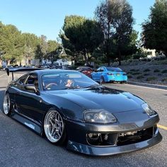 a black sports car parked on the side of the road