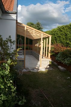 a wooden structure in the middle of a yard