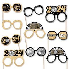 some black and gold photo booth props with glasses on them for a new year's eve party