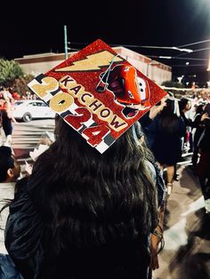 a person wearing a graduation cap with the words acrobatia printed on it