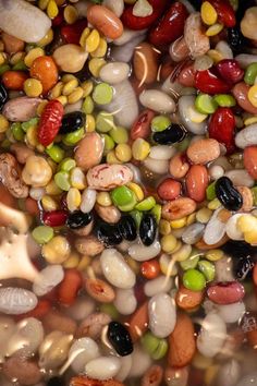 beans, corn and other vegetables are mixed together in a pot to make a soup