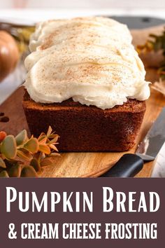 pumpkin bread and cream cheese frosting on a wooden cutting board with pine cones in the background