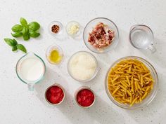 the ingredients for pasta are laid out in bowls