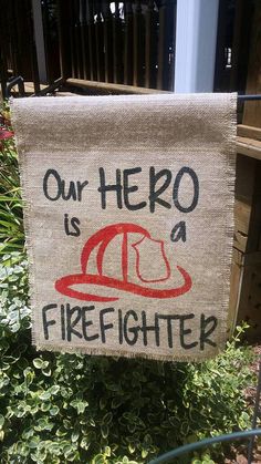 a sign that says, our hero is a firefighter with a hat on it